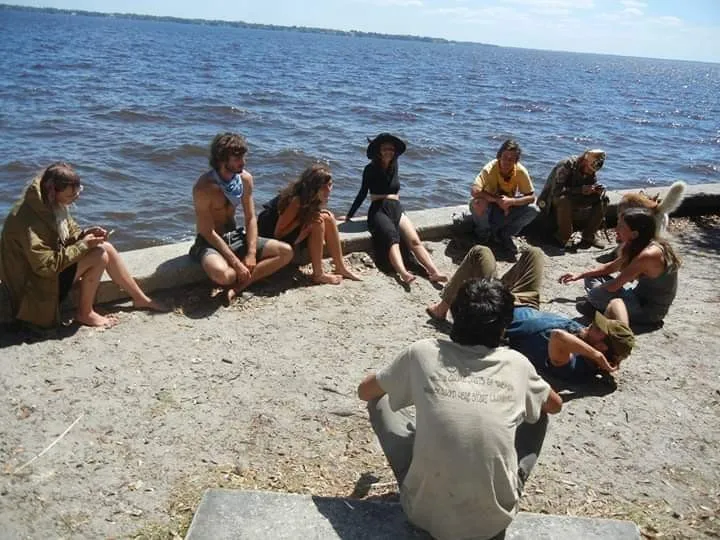 Community members gathered outdoors beside the water